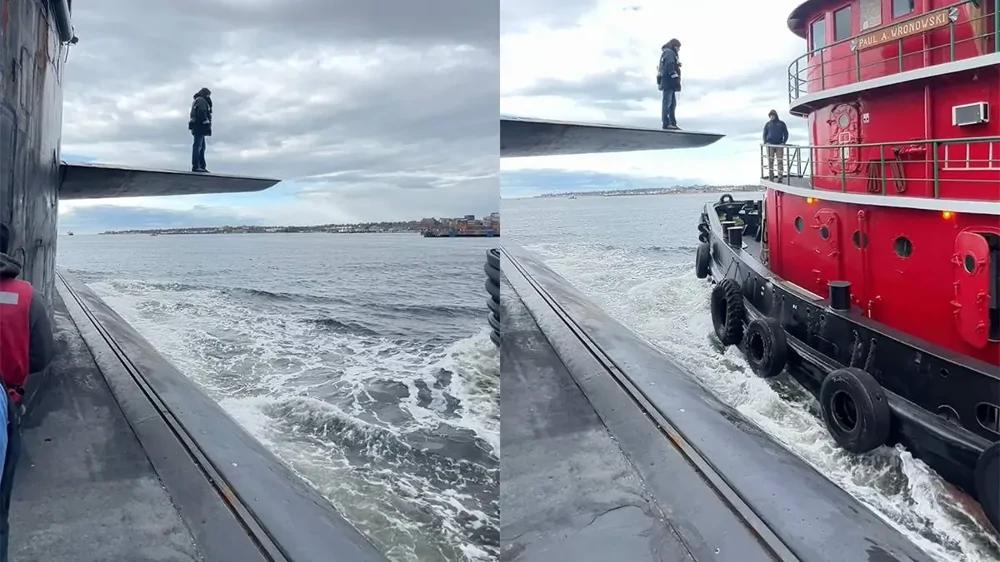 
        Мужчина шагает с&nbsp;подводной лодки на&nbsp;другой корабль в&nbsp;открытом море    